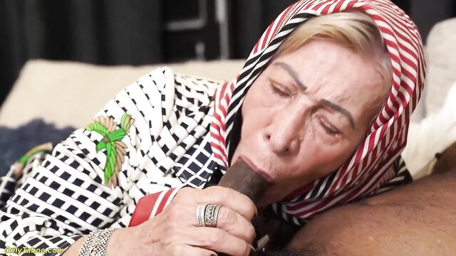 Veiled mature granny eagerly sucking thick black cock closeup
