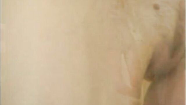 Blurry nude woman bound spread-eagle on cross in painful bondage