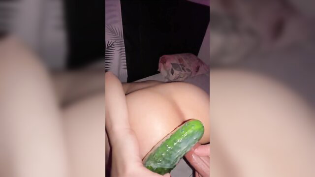 Amateur babe teases shaved pussy with cucumber toy closeup