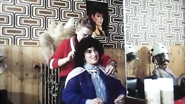 Retro 1983 salon scene: brunette stylist brushes young woman's curly hair