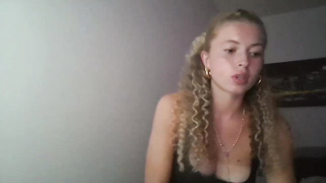 Sara Baller blonde curvy Chaturbate camgirl in low-cut top, sexy smile