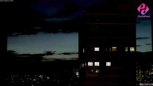 Night city skyline view from high-rise window, dark silhouette buildings