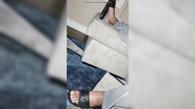 Hot babe's bare foot and black flip flop tease on floor