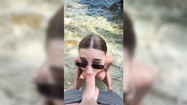 Blonde babe in sunglasses gives POV blowjob on sunny beach