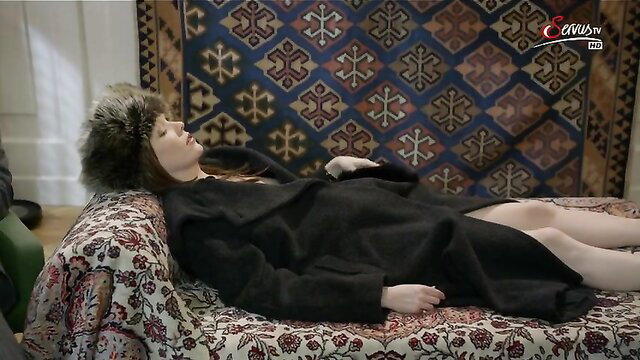 Stefanie Dvorak nude tits lying on couch in fur hat black dress
