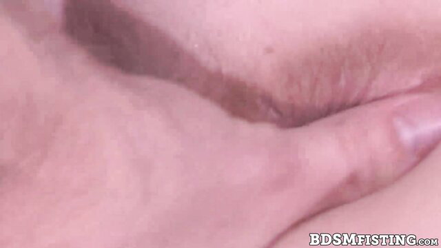 Closeup of stretched anus in extreme fisting BDSM scene