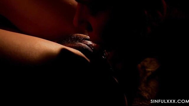 Brandi Love passionately kissing Andy Love in dim-lit scene