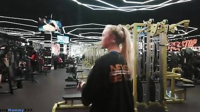 Blonde bombshell in hoodie at Never Stop gym, fit body tease