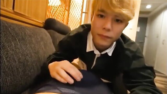 Blond Asian twink in school uniform gropes crotch on couch in gay JAV