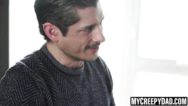Creepy stepdad in sweater gazes intensely, thumbnail for gay taboo deepthroat vid
