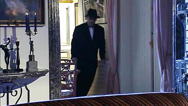 Mysterious man in tuxedo and hat in classy intimate Paris night setting