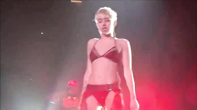 Sexy Miley Cyrus in skimpy red bikini on stage, hot body tease