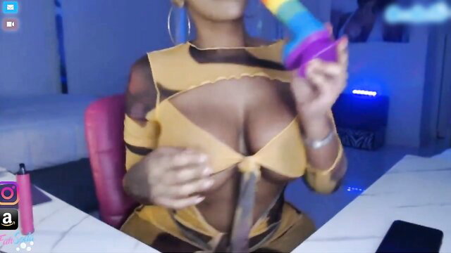 Katt Leya teasing with huge tits in sheer yellow lingerie, holding dildo