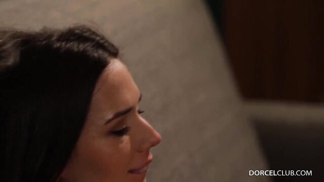 Closeup of seductive brunette beauty smiling in dim light