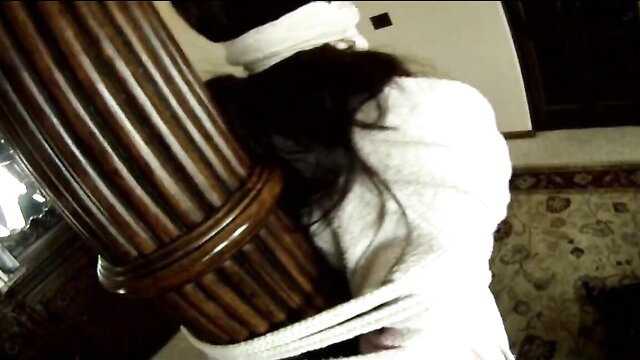 Beautiful wife bound to post in humiliating bondage by husband