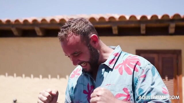 Bearded man in Hawaiian shirt excited near Alexis Cherry