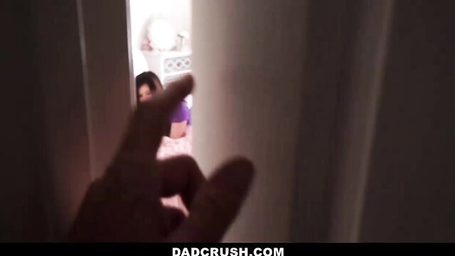 Stepdaughter in purple top and shorts teases stepdad with finger gesture from doorway