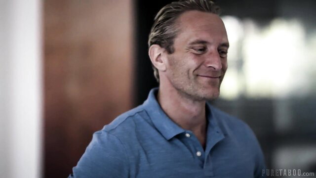 Handsome mature man smiling in blue polo shirt closeup