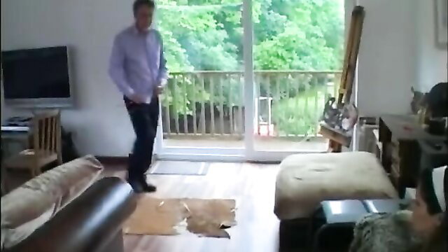 Man stands behind woman bent over in doggy for butt caning punishment