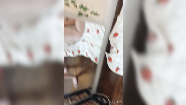 Blurry amateur solo woman in strawberry print dress on bed
