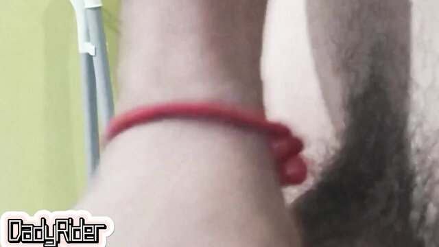 DadyRider milks thick cock with hand, red bracelet on wrist