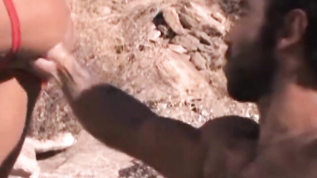 Muscular bearded man fists woman's arm in intense outdoor fisting scene