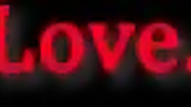 Red 'LOVE' neon sign glowing on black, sexy vibe for Madison Morgan MILF porn