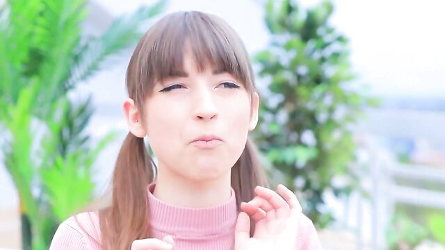 Cute Japanese girl with bangs, pigtails, big mouth pout in pink turtleneck