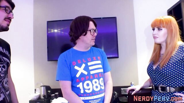 Tattooed redhead Brit in dress with two nerdy guys in threesome preview