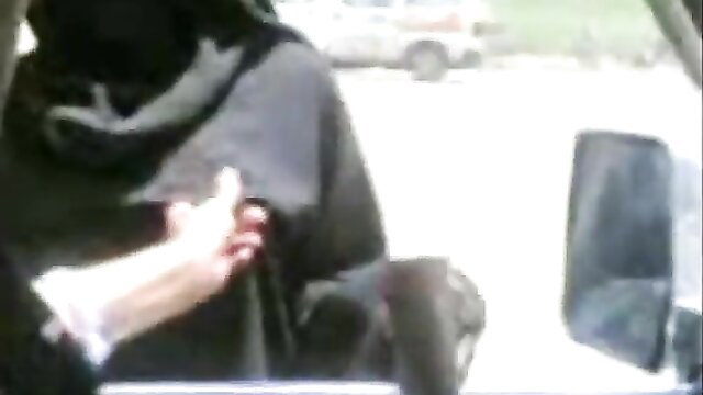 Arab woman in black niqab abaya grabs cash from man's hand in car