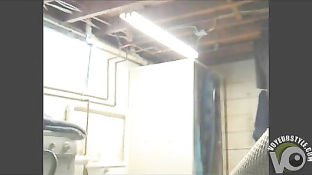 Curvy brunette stripping totally naked in basement laundry room