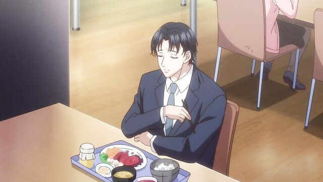 Handsome Japanese businessman in suit eating lunch at table
