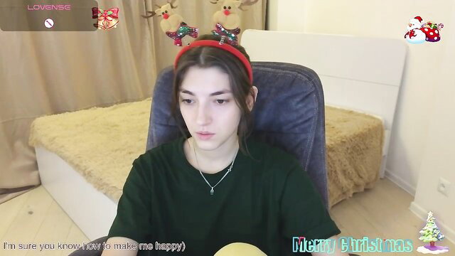 EmmaCherry7 in green sweater, red headband, Merry Christmas striptease