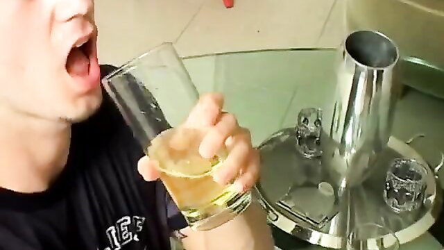 Wooly dude Kaleb Scott holds beer wide mouth open, pee play setup