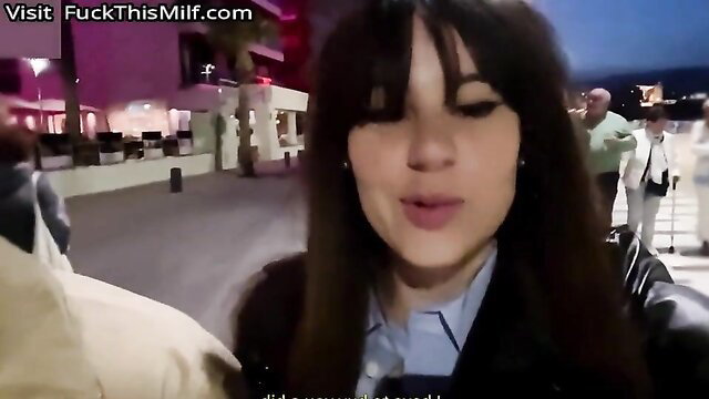 Gorgeous brunette bimbo in leather jacket smiling at POV camera outdoors