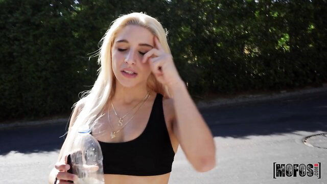 Abella Danger blonde in black sports bra rubbing eye outdoor POV tease