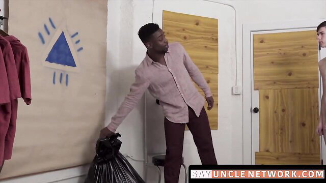 Black man grabs trash bag with young twink in doorway on SayUncle