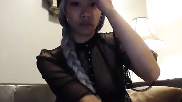 Mochi Munchies Asian beauty in sheer black top, silver braids, seductive pose