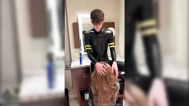 Cute latex guy gropes long-haired transgirl's head in fetish scene