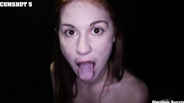 Redhead amateur sticks out tongue at gloryhole awaiting cumshot