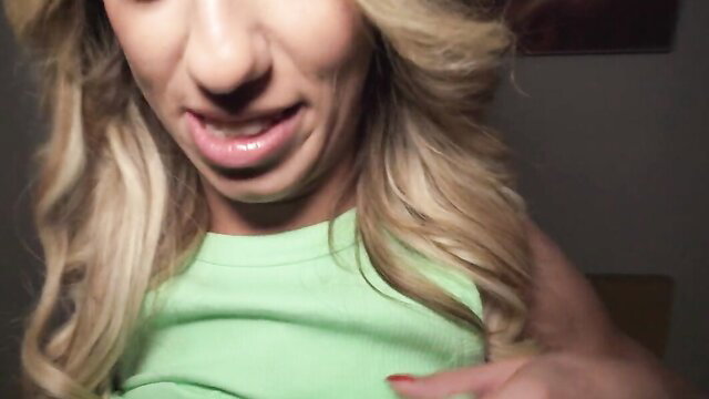 Blonde babe in green top teases with naughty tongue out, lingerie bet tease