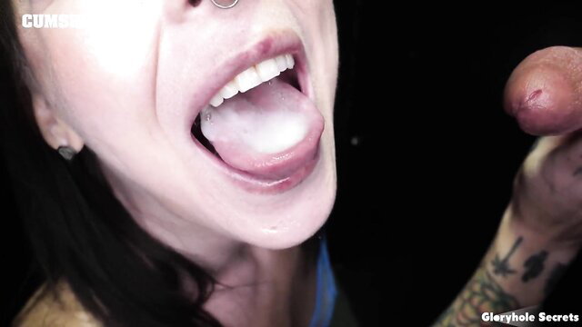 Brunette woman licking man's finger through a gloryhole