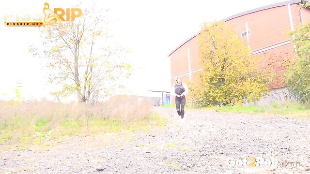 Blonde woman in black dress walks outdoors in PissRIP piss fetish compilation thumbnail