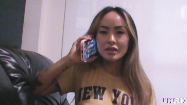 Linda Lan on phone call in sexy New York tee, hot Asian amateur thumbnail