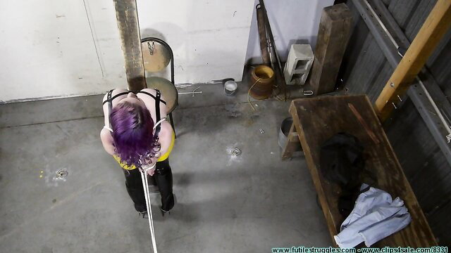 Gia Love bound in latex, arms tied overhead in FutileStruggles shoot