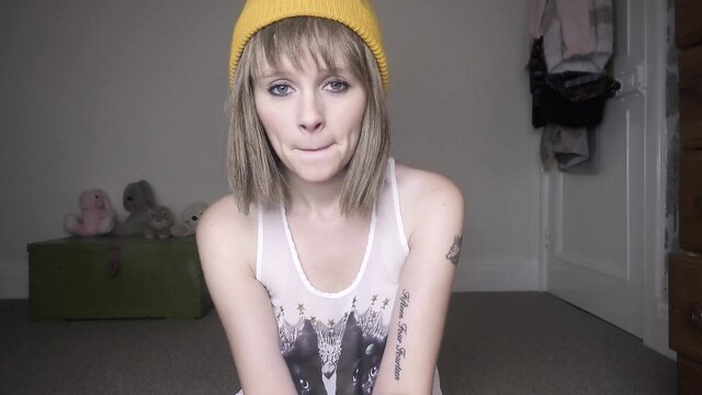Sydney Harwin in yellow beanie and tank top teases playfully