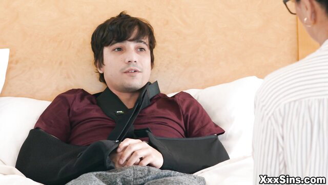 Man restrained in bed with woman in sexy nurse outfit during wild sex play