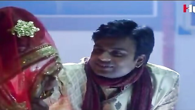 Indian bride and groom in close embrace, wedding attire tease