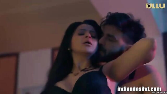 Hot Indian couple in black lingerie kissing passionately, ULLU web series sex scene