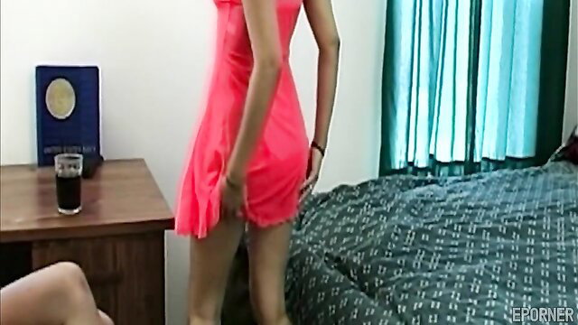 Tyce Bune in tight pink dress bends over bed teasing ass